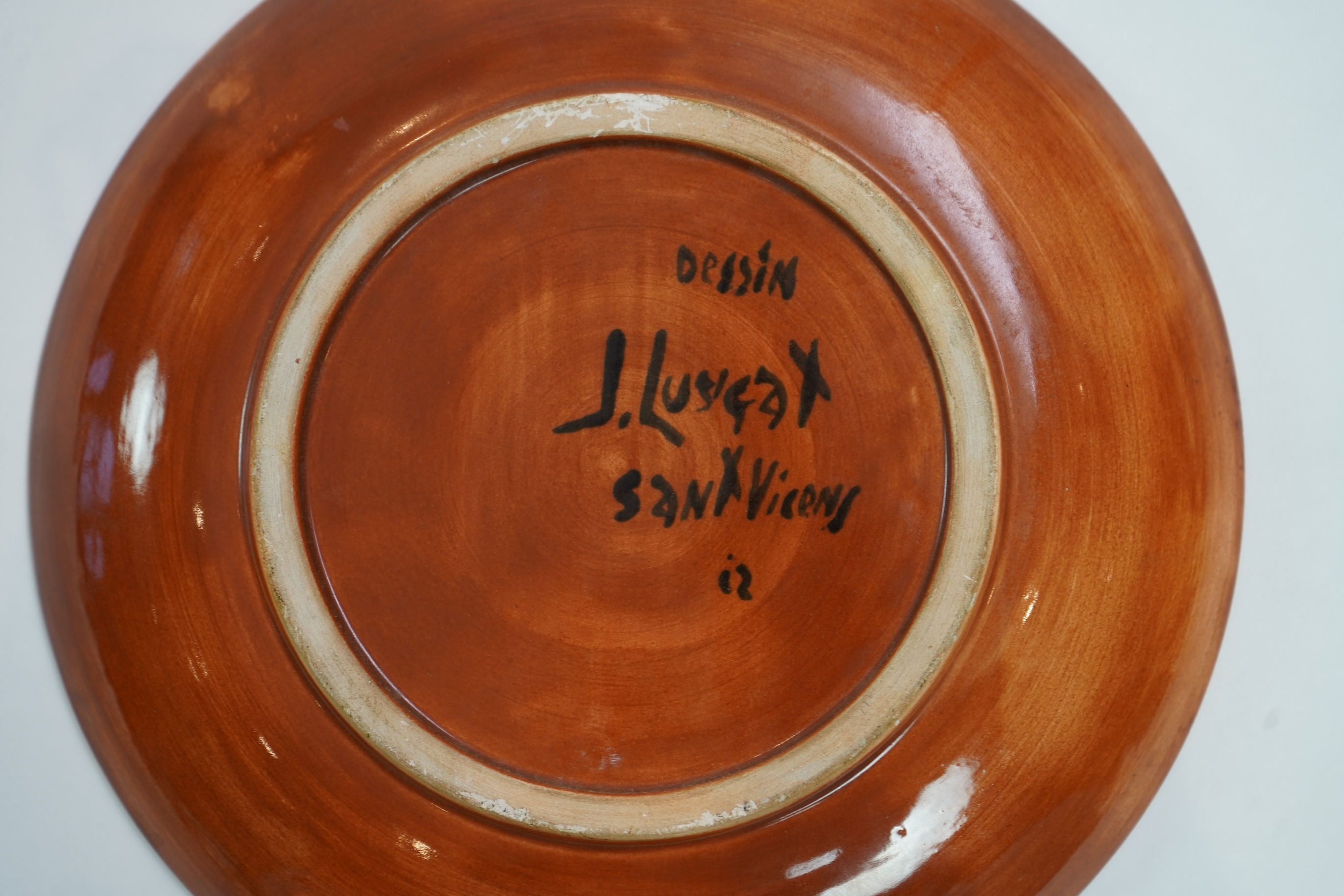 Jean Lurçat (1892-1966): A rust glazed earthenware plate, decorated with a stylised central figure